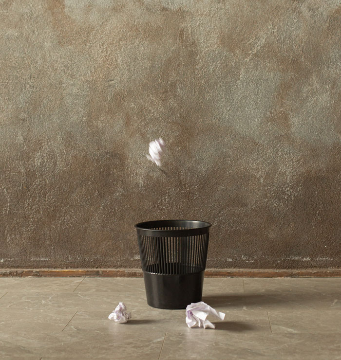 throwing trash in the trash can