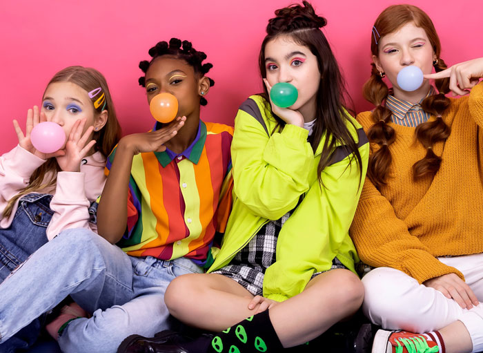 Girls blowing bubble gum bubbles