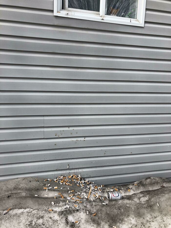 Trashy Neighbors That Dump Their Beer And Buts Out Of Their Window Which Is Right On A Main Street Sidewalk Downtown