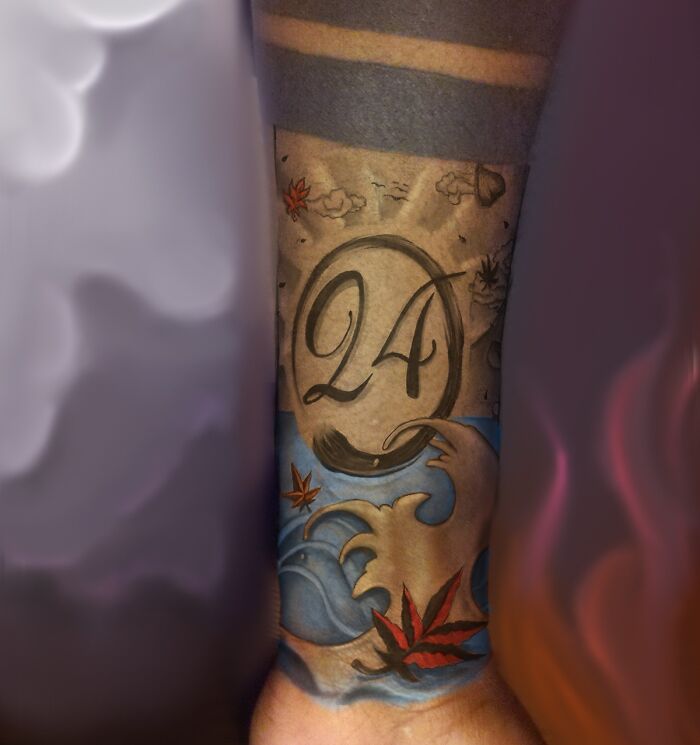 Armband tattoo with number 24, clouds, waves, and red maple leaves, showcasing creative armband tattoo design.