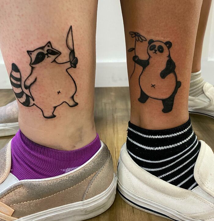 BFF tattoos of a raccoon with a knife and panda with a flower on friends' ankles, symbolizing friendship fun.