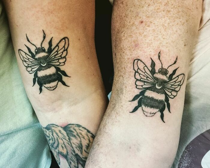 Matching bee tattoos on forearms, symbolizing friendship and unity, showcasing creative BFF tattoo ideas.