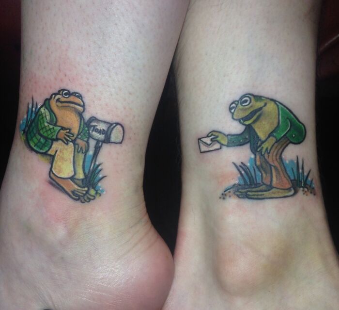 Frog and toad themed BFF tattoos on ankles, featuring a whimsical mail delivery scene.