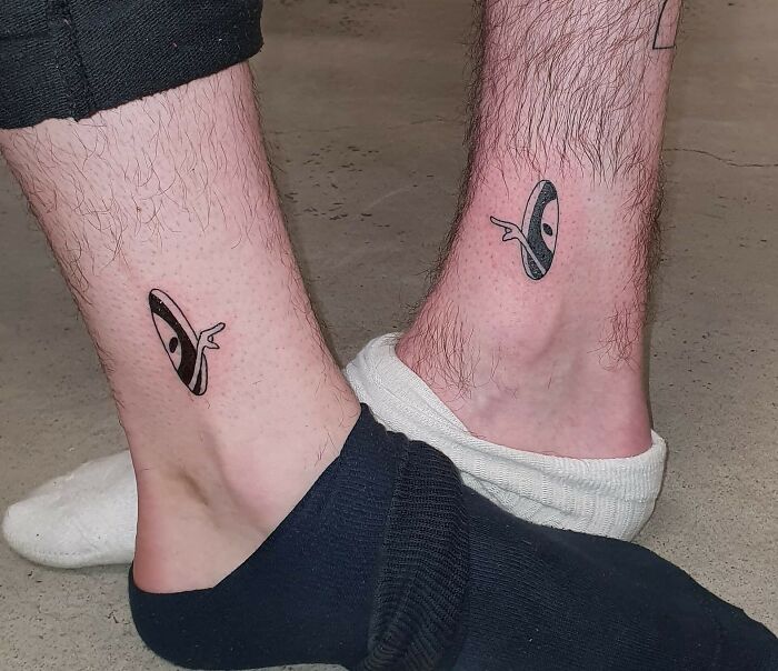 Matching UFO tattoos on ankles symbolizing friendship.