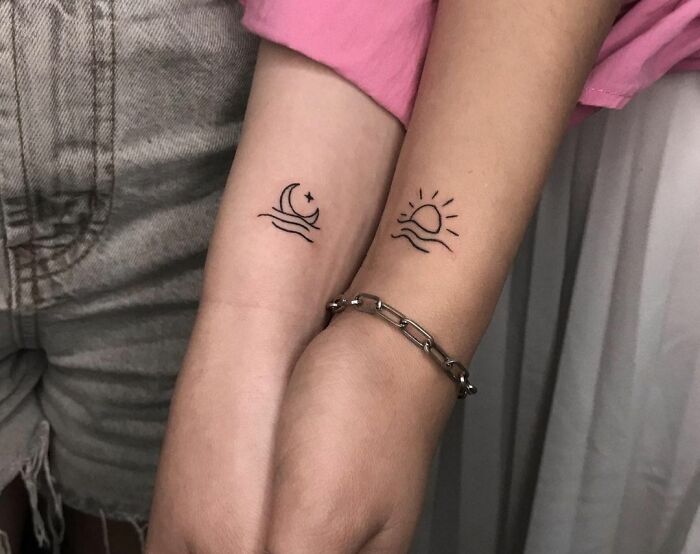 Moon and sun best friend tattoos on forearms, symbolizing friendship.