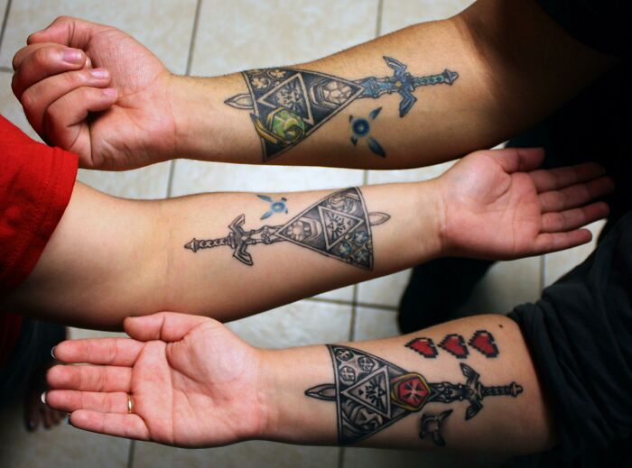 Brother and sister show matching sword tattoos on their forearms.