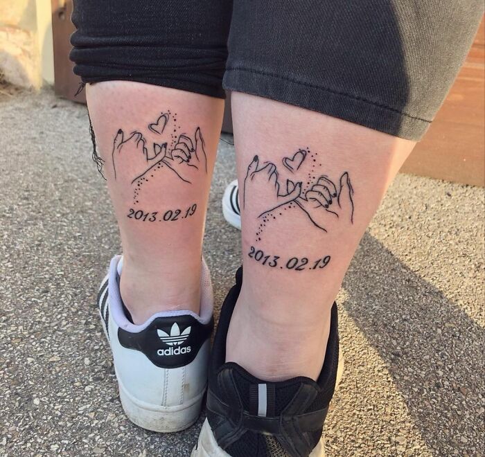 Matching BFF tattoos with pinky swear design and date "2013.02.19" on calves.