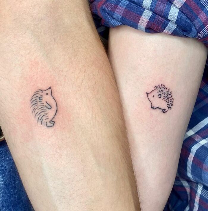 Two arms with matching hedgehog BFF tattoos, showcasing friendship tattoo ideas.