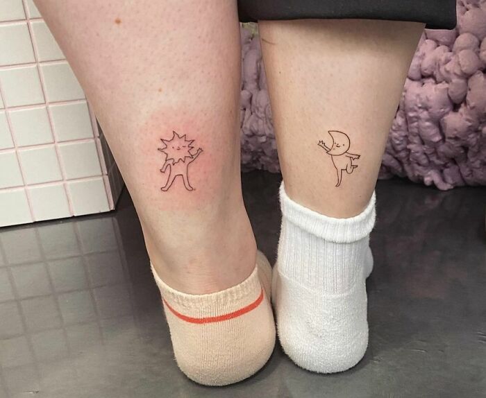 Two legs with matching minimal BFF tattoos featuring whimsical cartoon characters, highlighting friendship and fun.