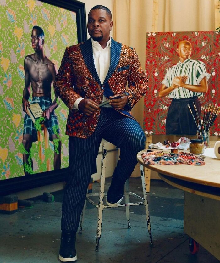 Picture of Kehinde Wiley with his paintings