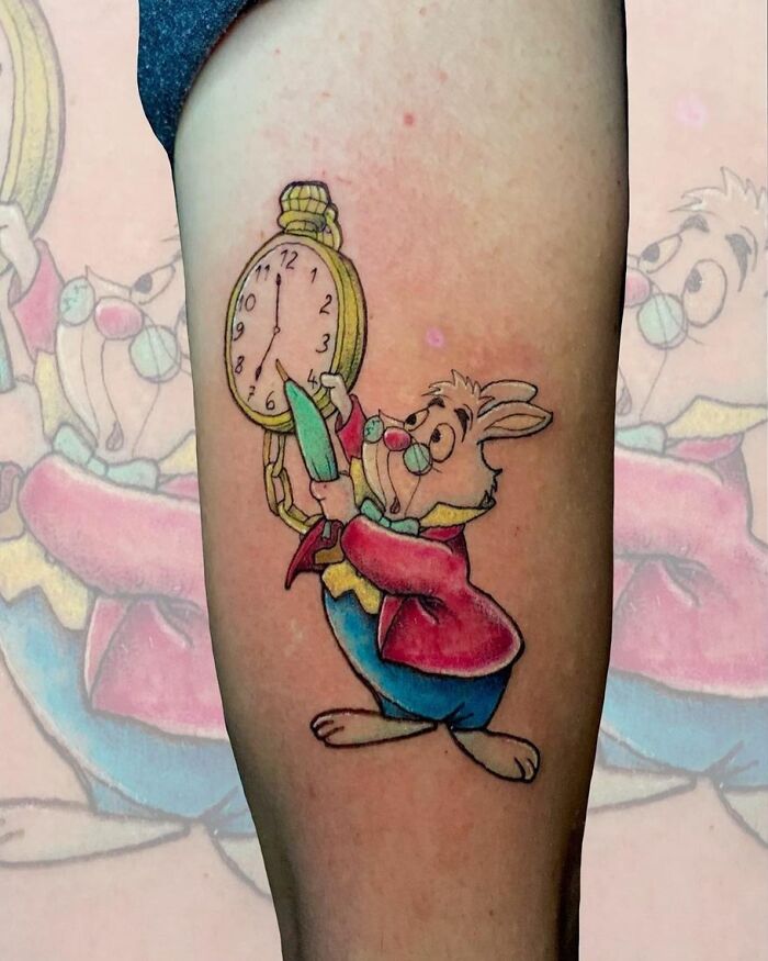 Cartoon tattoo featuring a time-obsessed rabbit from childhood favorites on an arm.