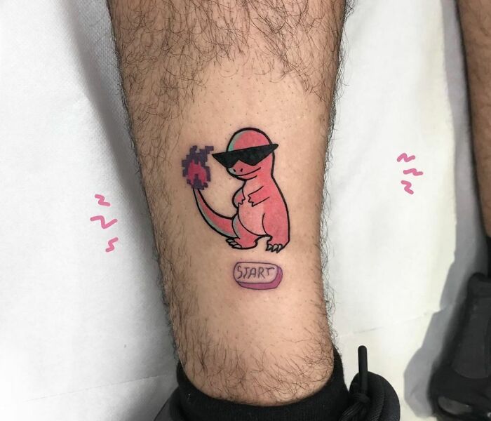 Cartoon tattoo of a pink dinosaur wearing sunglasses, holding a pixelated item, with a "start" button beneath.