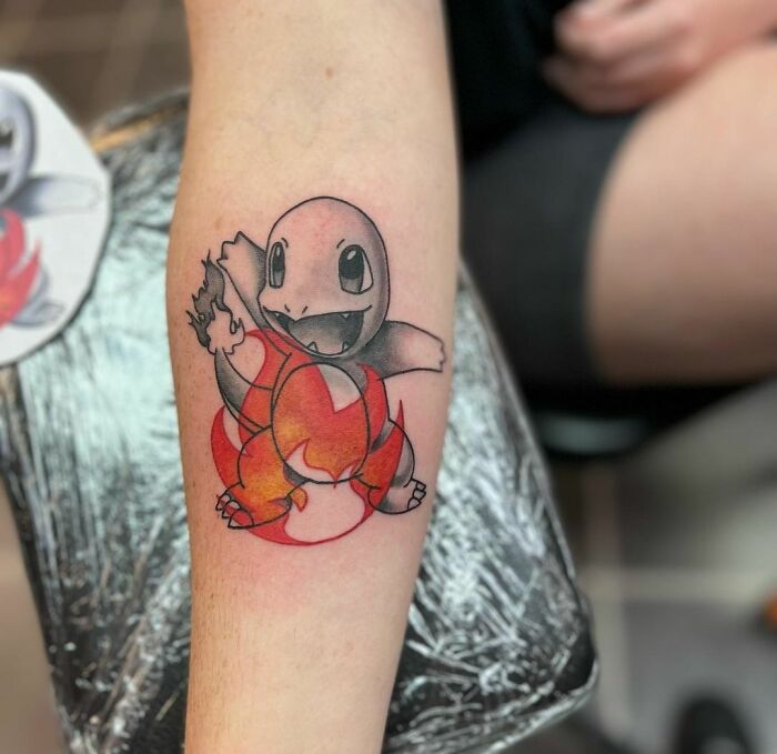 Cartoon tattoo of a fire-themed character from a beloved animated show on forearm.