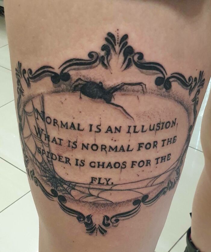 Decorative word tattoo with spider, featuring quote about normality and chaos, ideal for new ink inspiration.