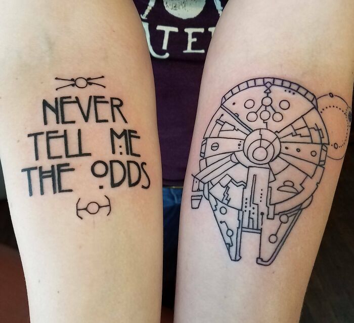 Creative word tattoos on arms featuring "Never Tell Me The Odds" and a spaceship design for inspiration.