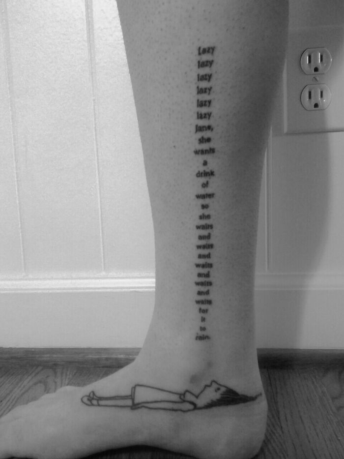 Text tattoo on leg featuring poetic words and illustration, showcasing inspirational word tattoos.