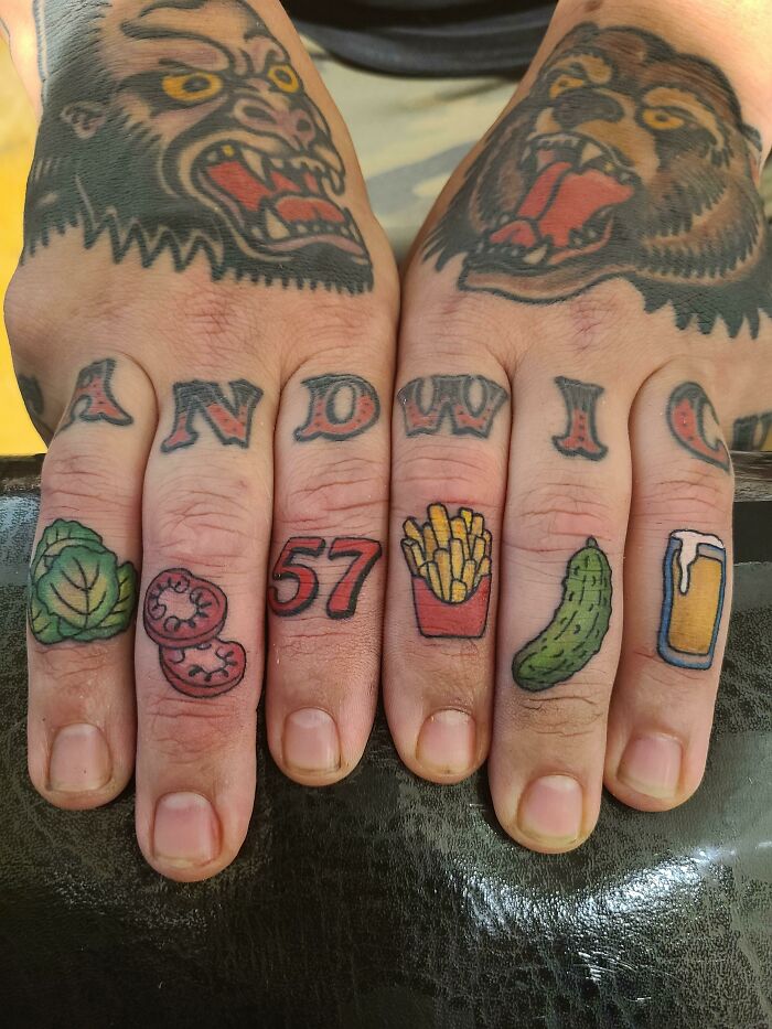 Creative word tattoos on fingers with food icons and animal motifs.