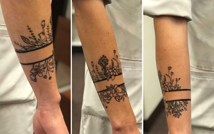 Floral armband tattoo design with intricate details on forearm.