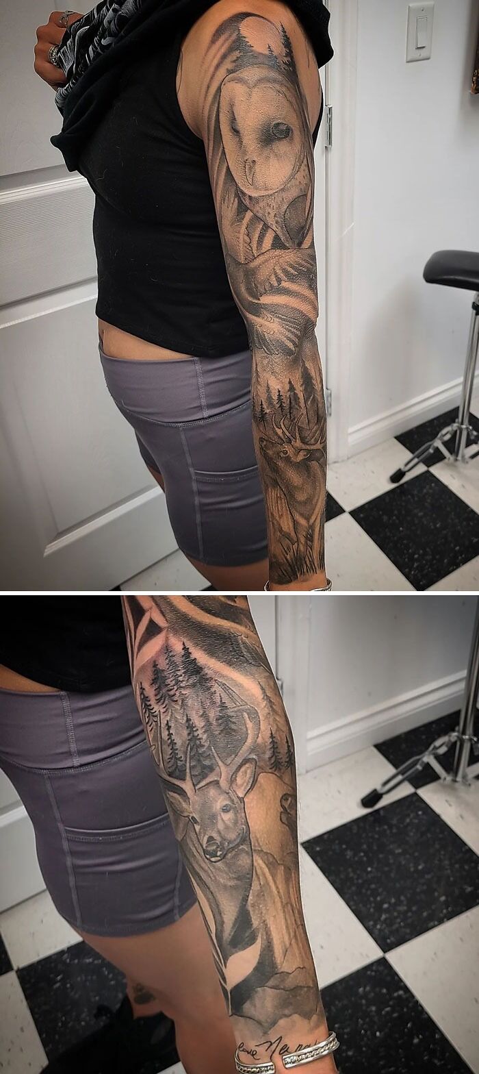 Arm with animal tattoos featuring an owl and a deer in a forest setting.