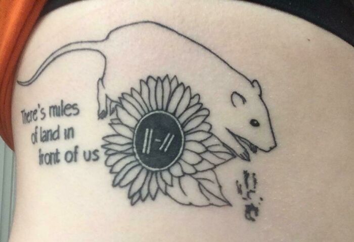 Pet tattoo featuring a rat and sunflower with text reading "There's miles of land in front of us."