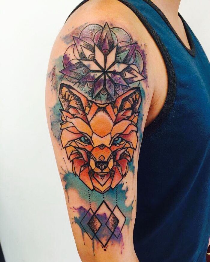Watercolor tattoo on arm featuring geometric fox and mandala design for inkspiration.