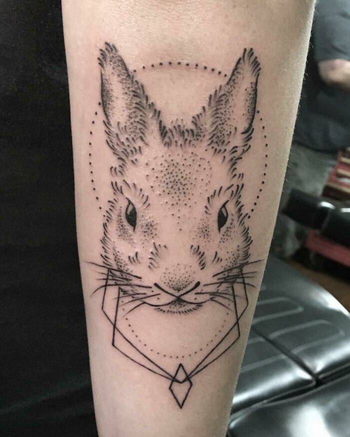 Pet tattoo of a rabbit with geometric design on a forearm, highlighting a love for furry friends.