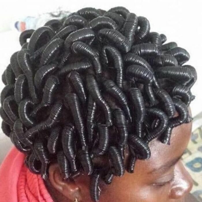 Creative bad haircut featuring tight, curled black hair that resembles coiled springs.