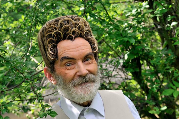 Man with a unique curly hairstyle and beard, standing outdoors, showcasing a bold haircut idea.