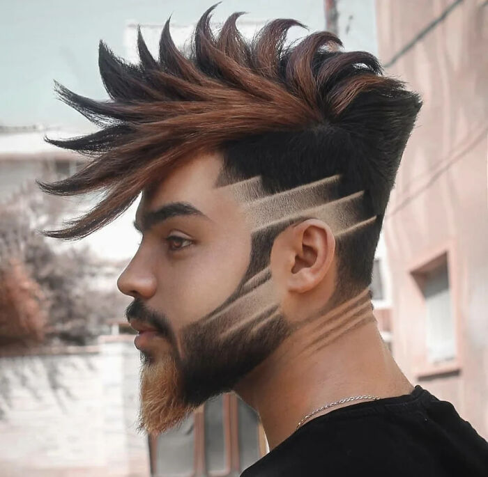 Unique bad haircut with angled spikes and geometric beard design.