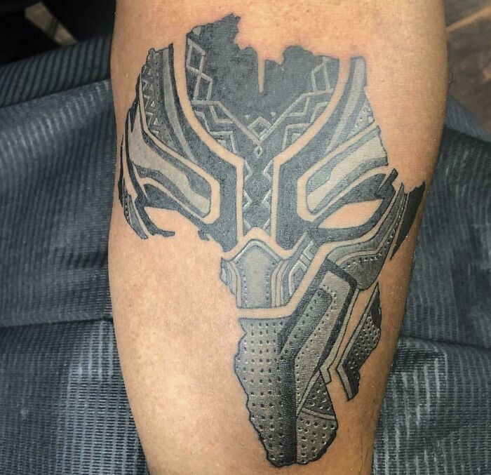 Black Panther inspired Marvel tattoo on forearm with detailed design.