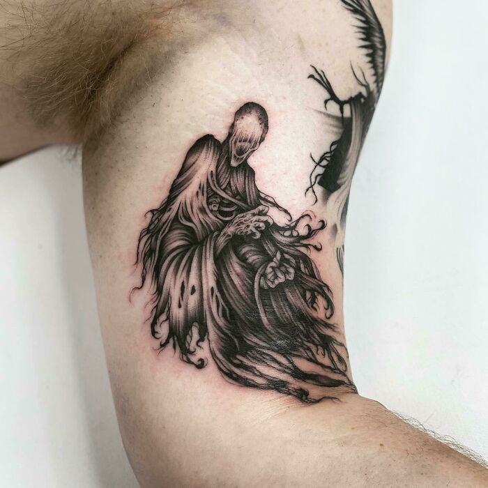 Harry Potter tattoo of a dark, ghostly figure with flowing robes, designed on an arm.
