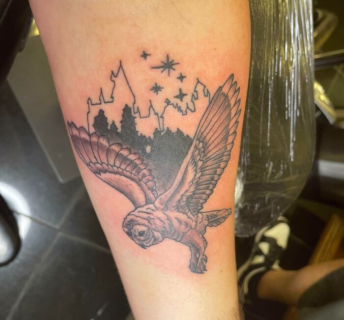 Harry Potter tattoo featuring an owl with Hogwarts silhouette on forearm.