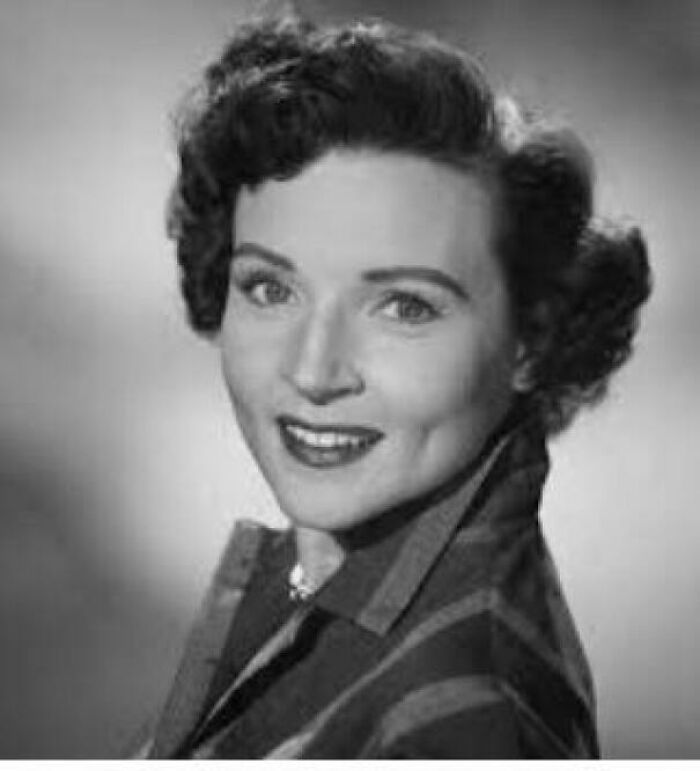 Black and white portrait of a smiling woman representing netizens highlighting big historical events from around a century ago.