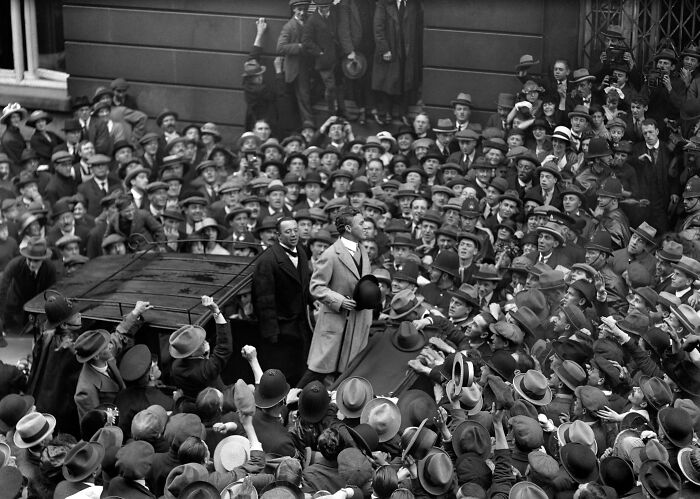Crowd gathered around a speaker in early 20th century, illustrating big historical events from around a century ago.