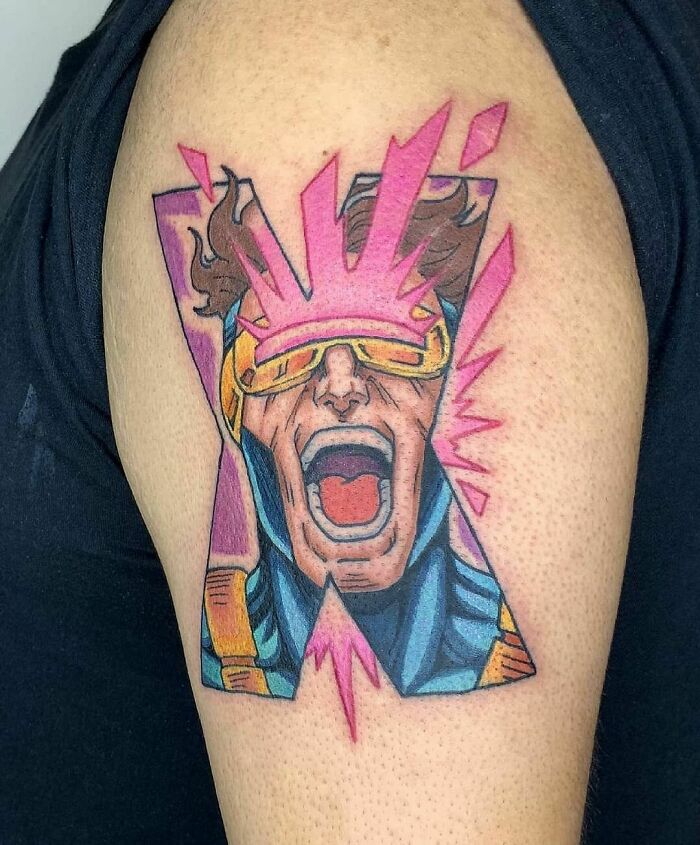 Marvel tattoo showcasing Cyclops on an arm, featuring vibrant colors and dynamic lines.