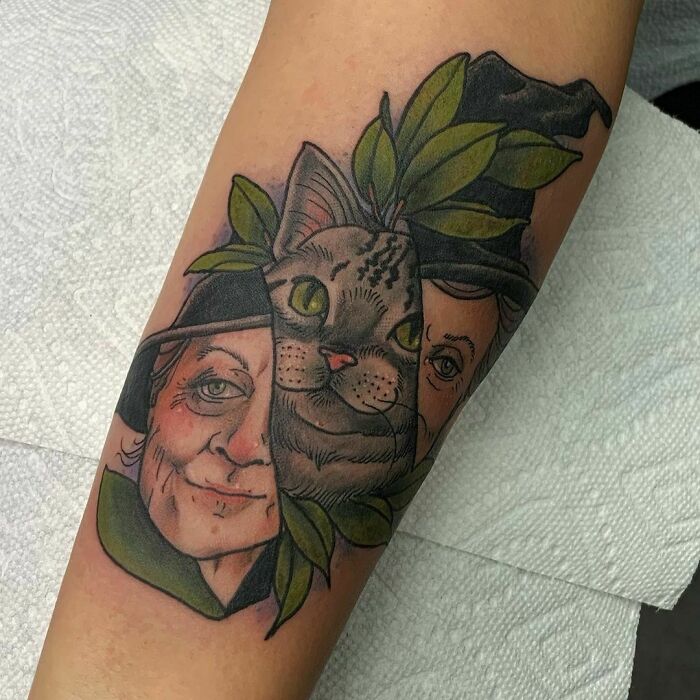 Harry Potter tattoo featuring a cat, witch, and leaves on forearm.