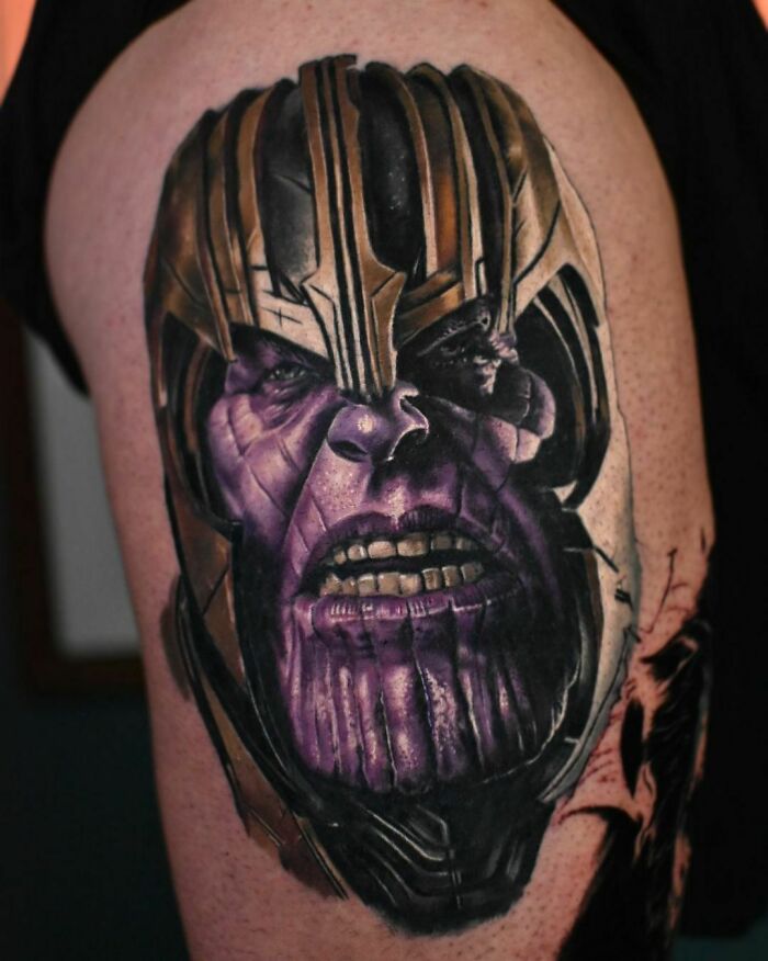 Tattoo of Marvel character Thanos with vibrant colors and intricate details on a person's upper arm.