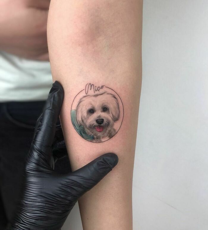 Pet tattoo of a dog's face on arm, showcasing the bond between humans and pets.