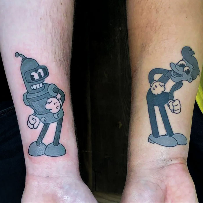 BFF tattoo ideas featuring two cartoon characters on forearms, representing friendship and shared humor.