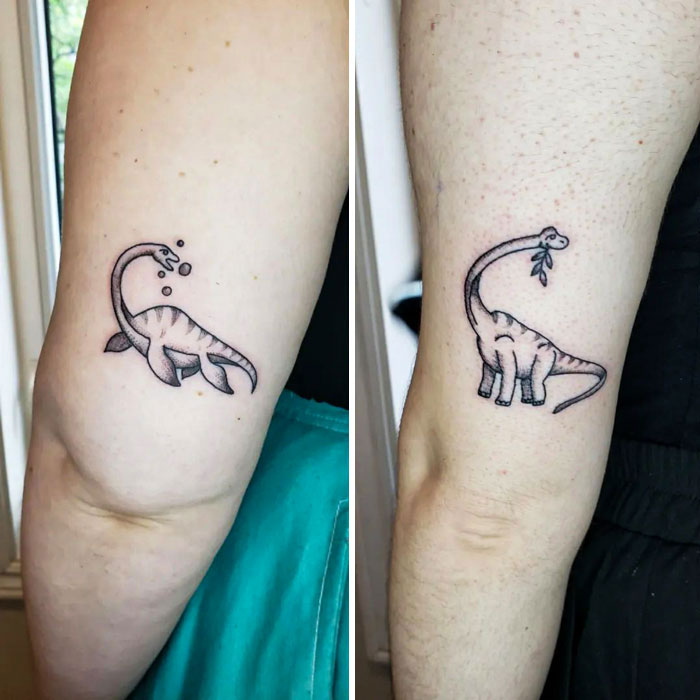 Two matching dinosaur BFF tattoos on arms, symbolizing friendship and fun.