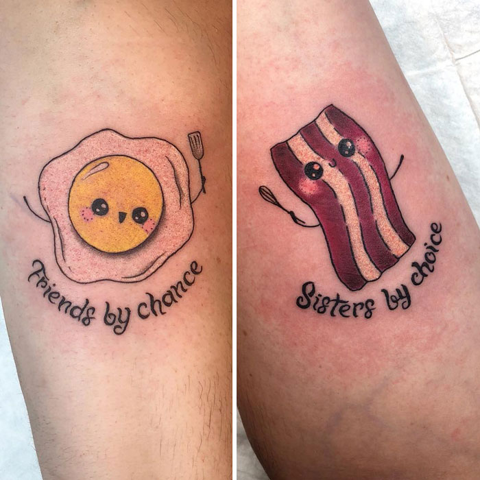 Cute BFF tattoos of a smiling egg and bacon strip with text "Friends by chance, Sisters by choice."