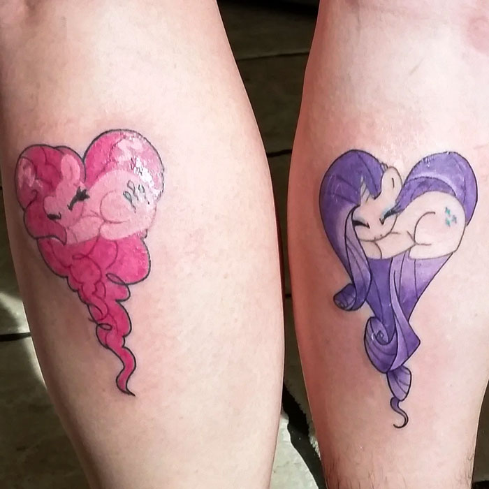 Matching best friend tattoos featuring pink and purple cartoon characters shaped like hearts.