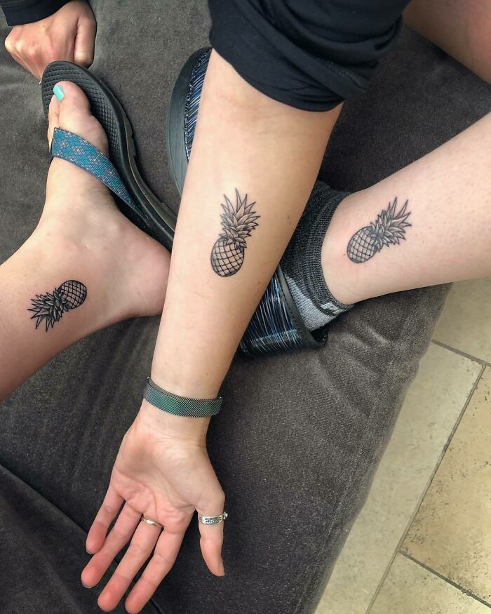 Brother and sister matching pineapple tattoos on their ankles.