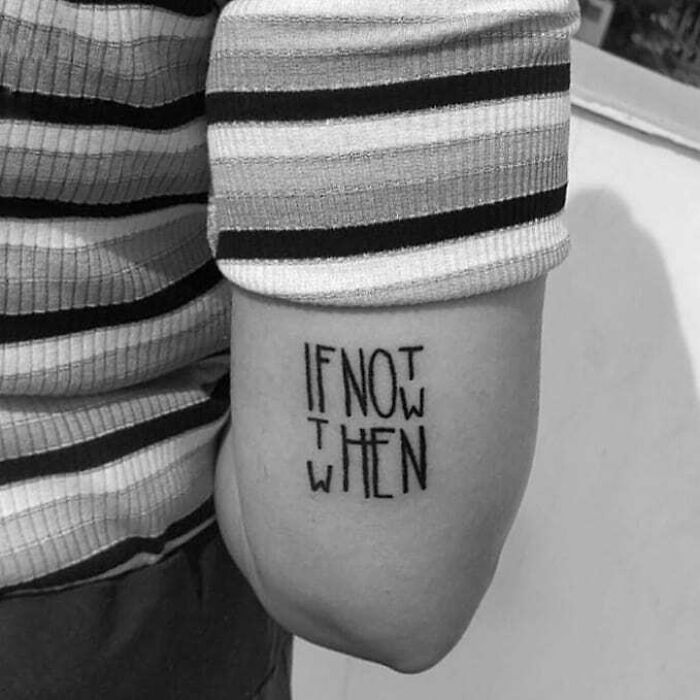 Tattoo with words "If not now, when" on a person's arm, showcasing inspirational word tattoos.