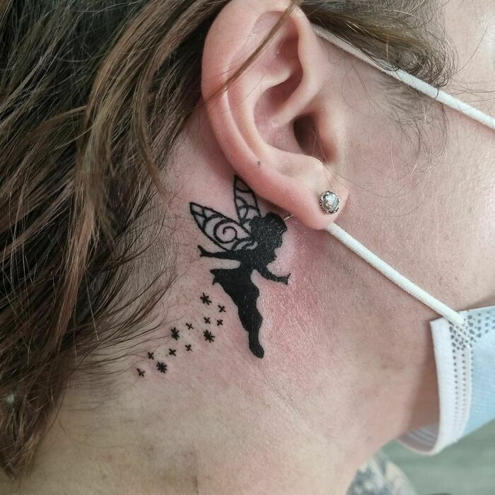 Fairy ear tattoo in black ink on person's skin, showcasing creative ear tattoo ideas.