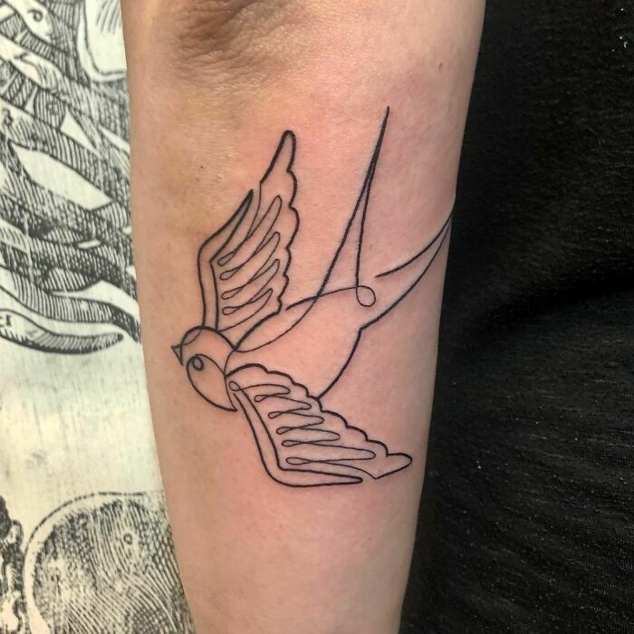 Minimalism line tattoo of a bird on forearm, showcasing unique and elegant design.
