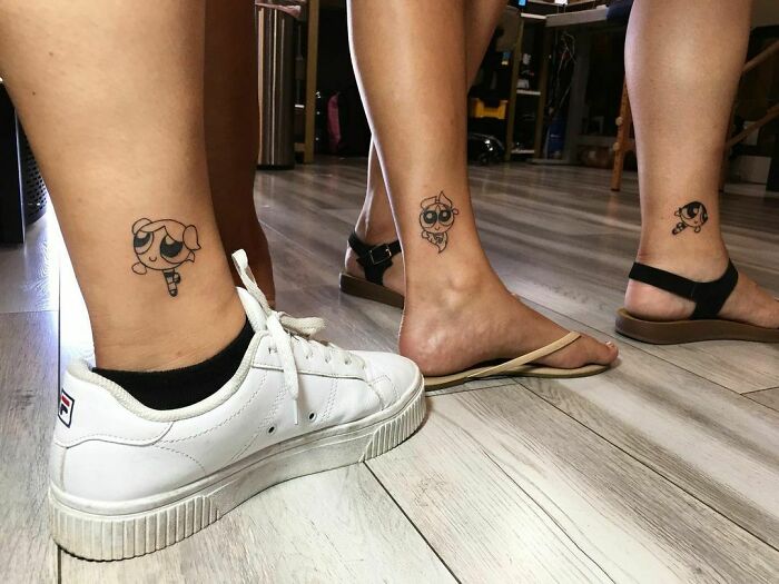 Small, simple brother and sister tattoos featuring cartoon characters on ankles in a casual setting.