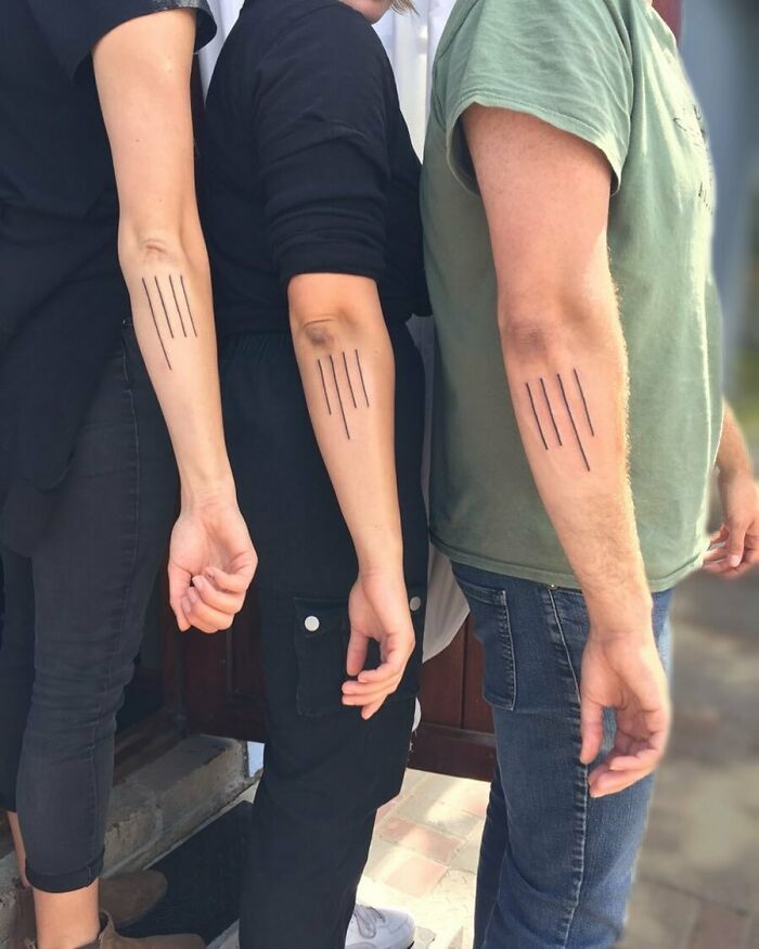 Three siblings displaying simple matching line tattoos on their forearms, symbolizing brother and sister bond.