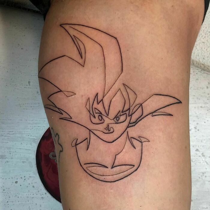 Single-line tattoo of an anime character in fine-line perfection on an arm.