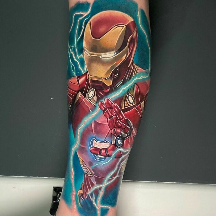 Marvel tattoo featuring Iron Man with glowing energy lines on a forearm.
